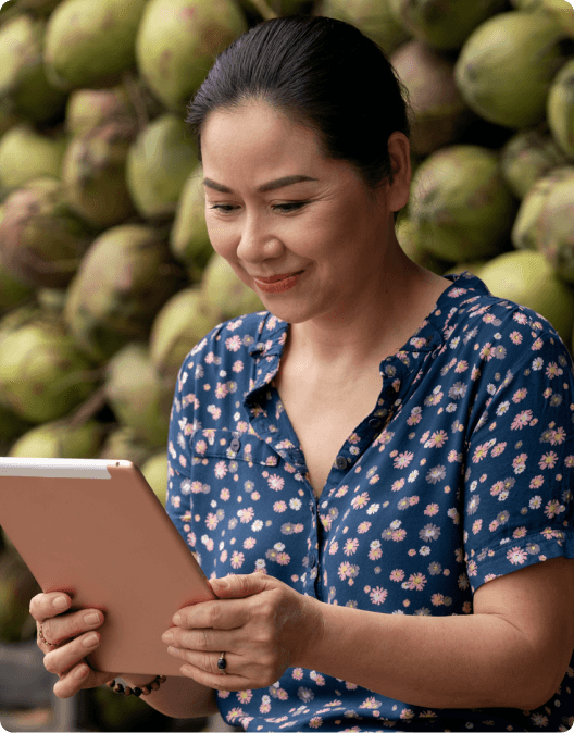 Vietnamese woman looking at her tablet