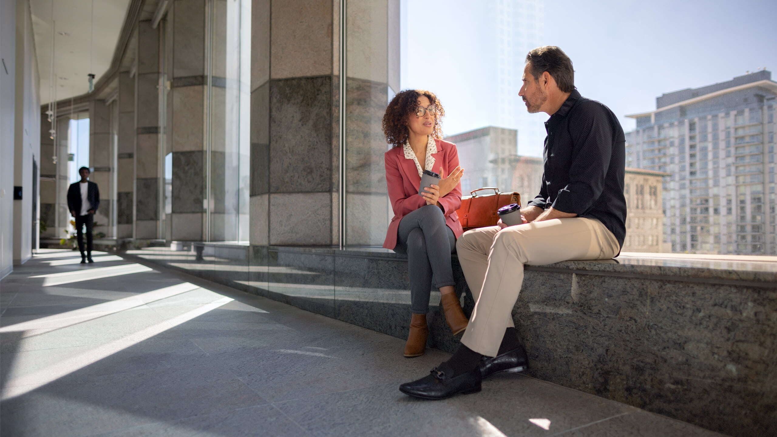 Two businesspeople talking in a walkway